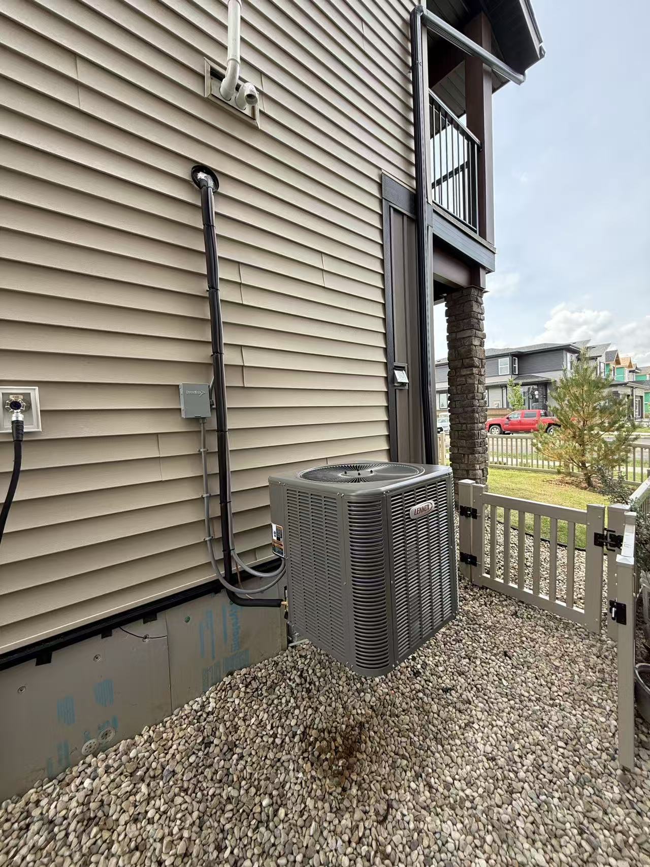 Outdoor Lennox AC installation on wall brackets